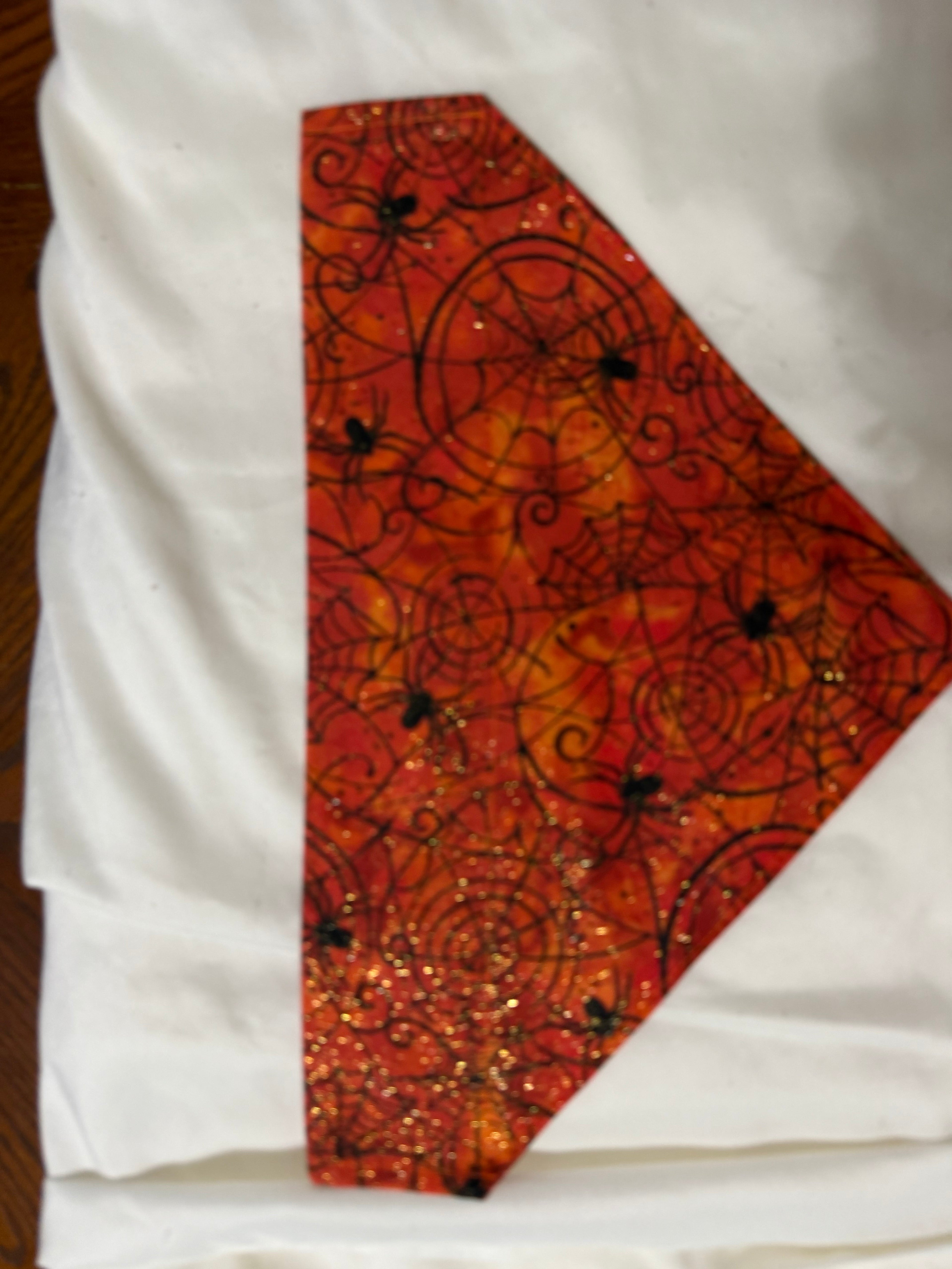 Halloween floral swirl pet bandanna in red and orange batik fabric with sparkle accents